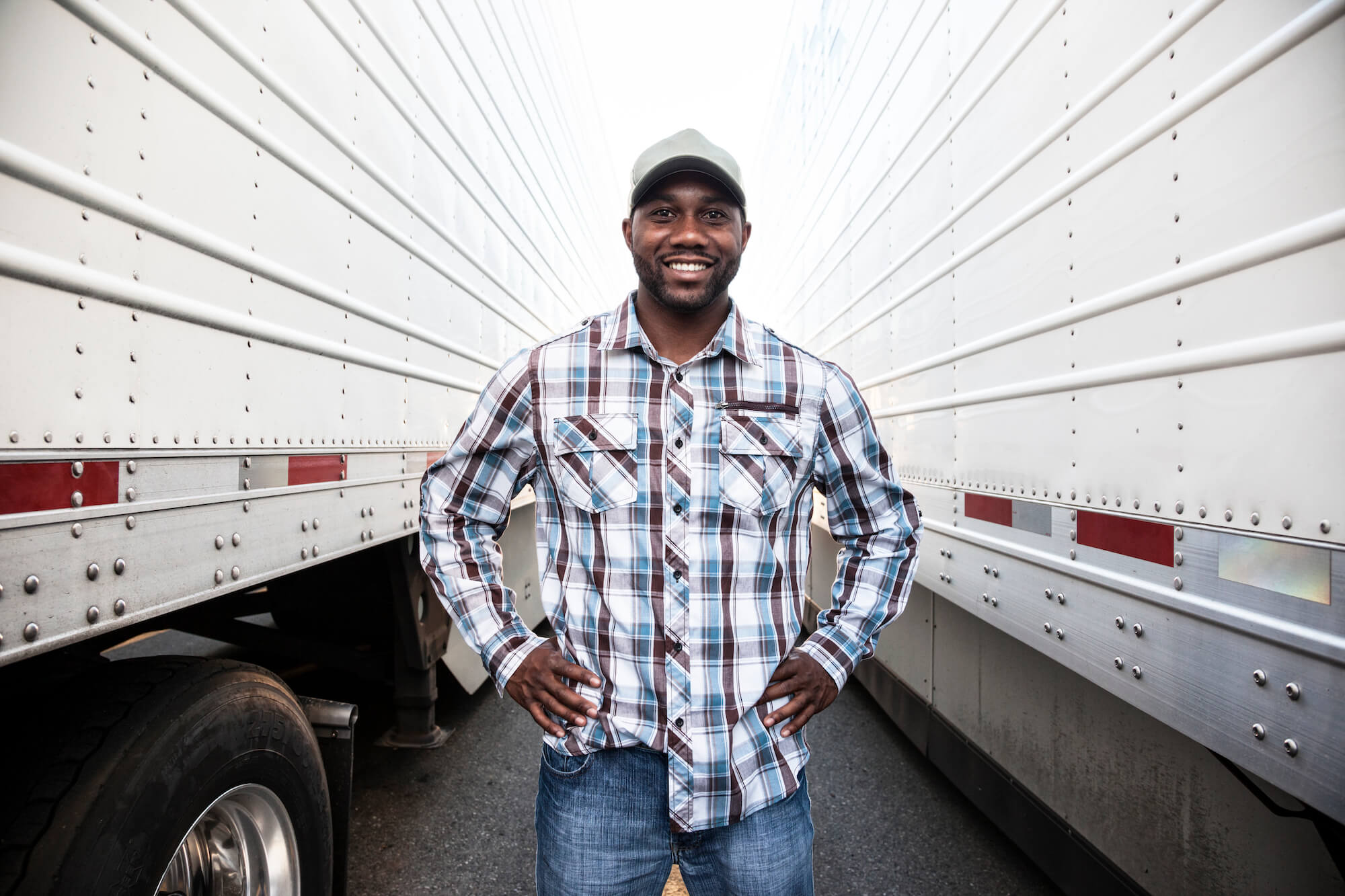 trucker-standing-by-his-large-truck-2021-08-29-09-02-09-utc